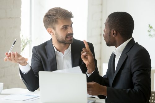 Two men arguing over legal papers